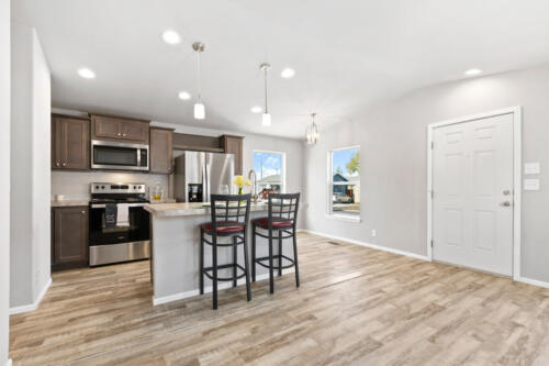 A kitchen with hardwood floors and stainless steel appliances.